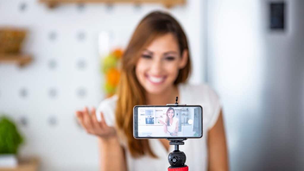 a woman smiling and holding a phone -Micro-Influencer